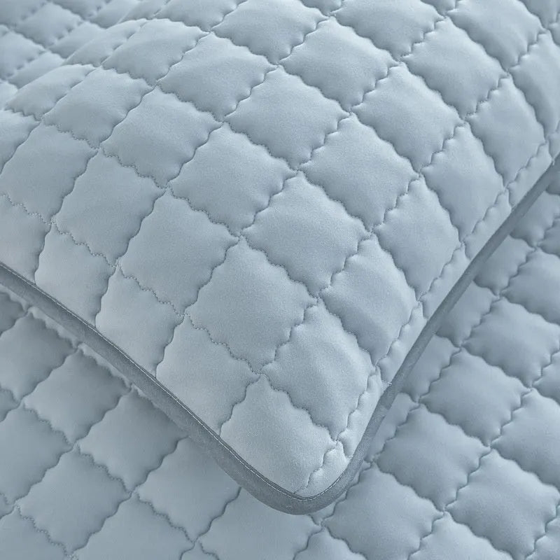 Class A waterproof fitted sheet in light grey colour, shown fitted neatly on a mattress.