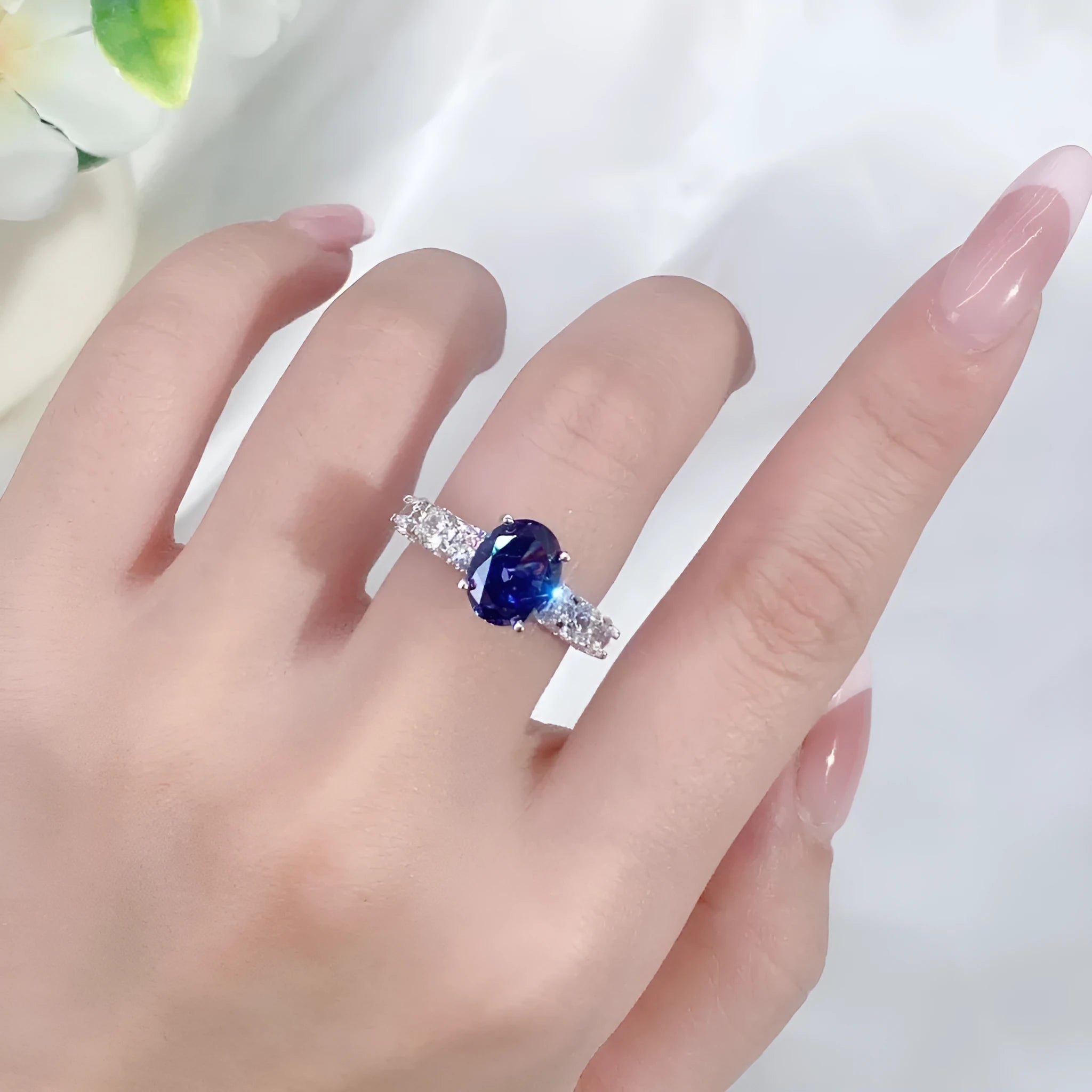 Heart shaped Tanzanite purple zircon ring in sterling silver on a grey background.