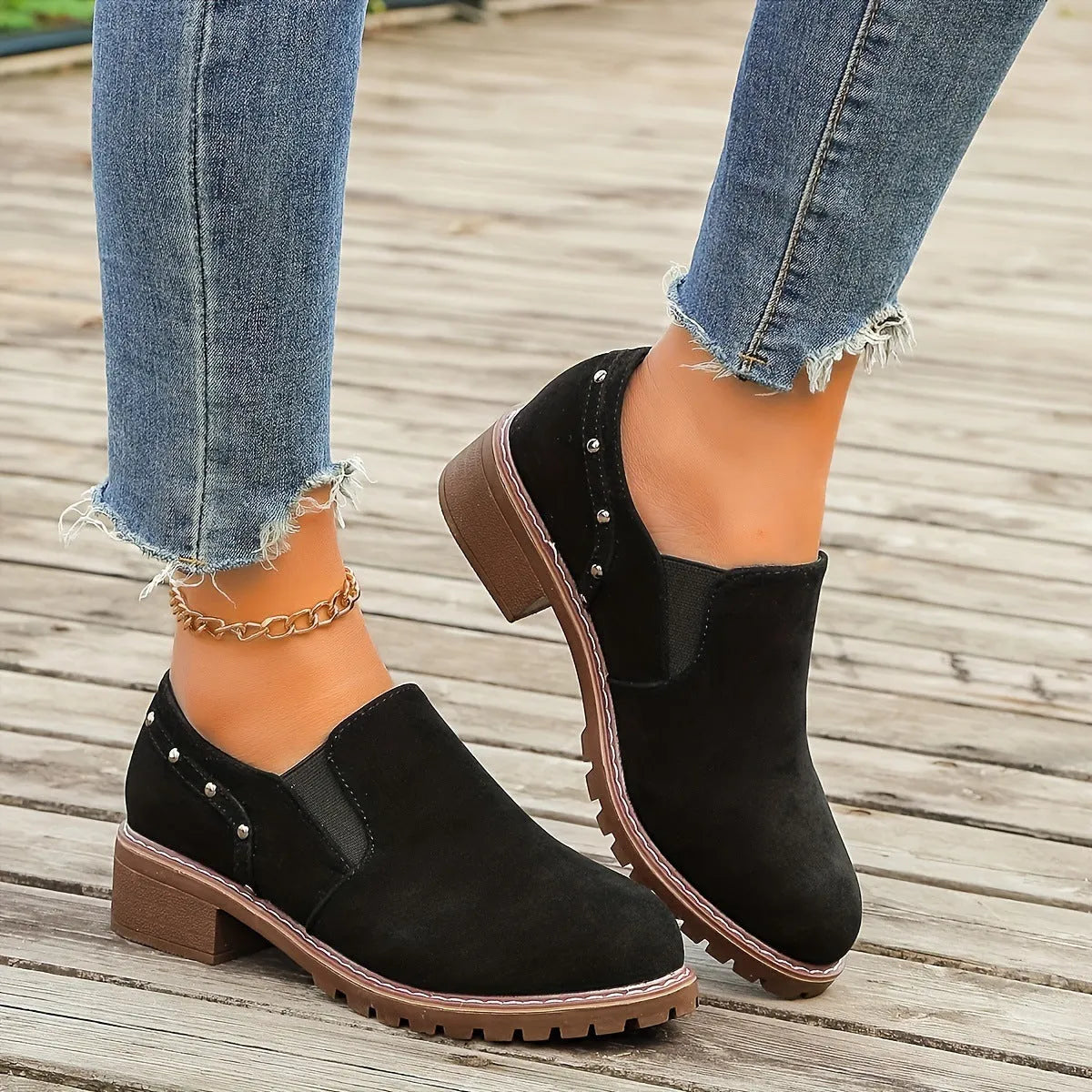 Women's light brown suede ankle boots with a low stout heel and elastic band at the ankle.