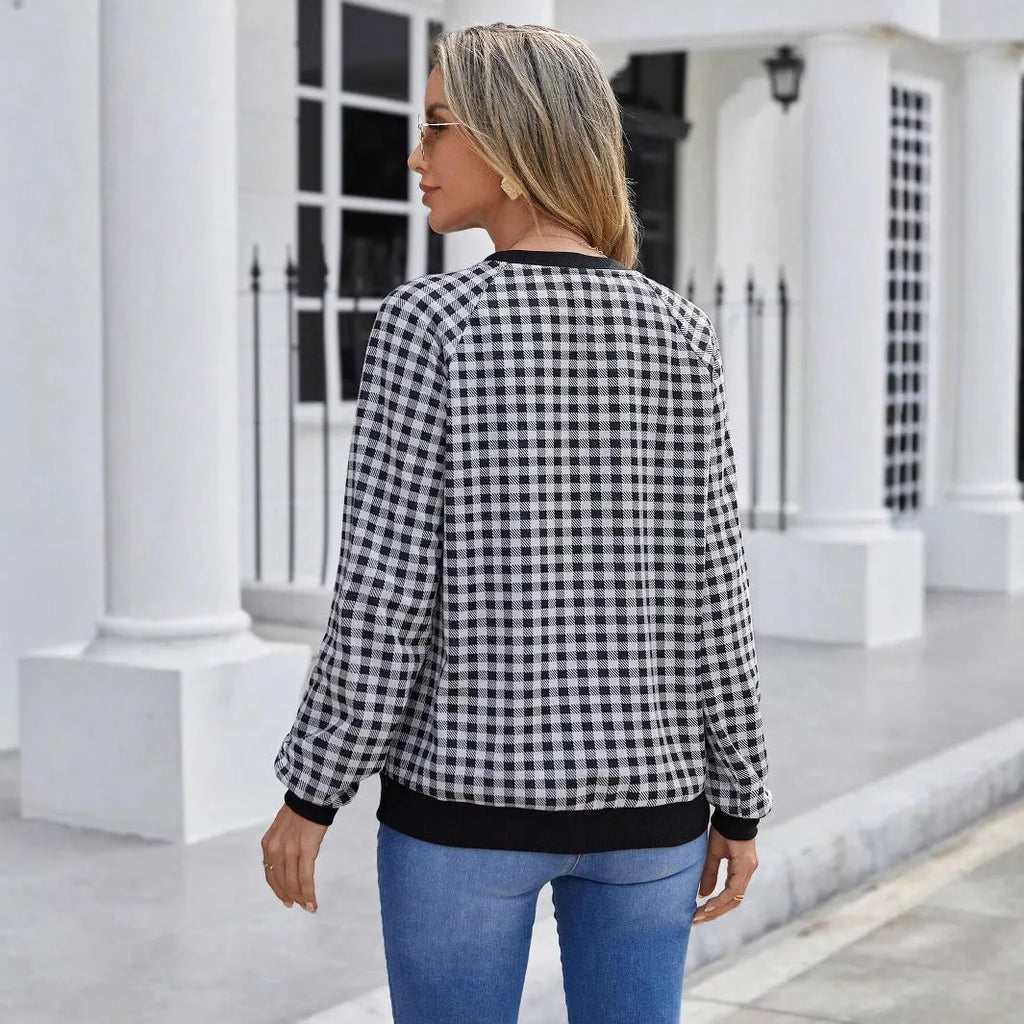 Black long sleeve pullover sweater with printed plaid and stripe pattern on a mannequin