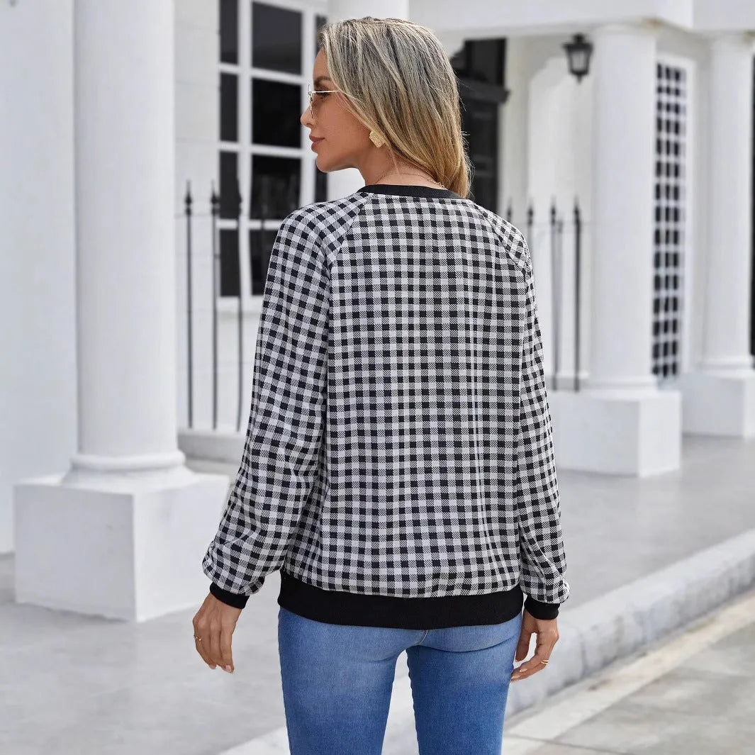 Black long sleeve pullover sweater with printed plaid and stripe pattern on a mannequin