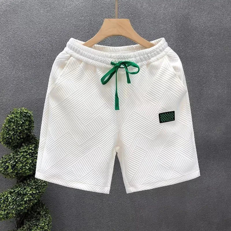 Men's solid colour polyester sports shorts with micro elasticity in white, black, or green.