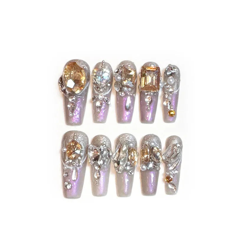 Rhinestone-decorated false nail patches on card packaging with application adhesive and tools