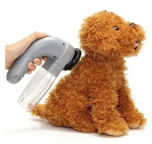 Gray portable electric pet hair remover with soft rubber head and collection canister.