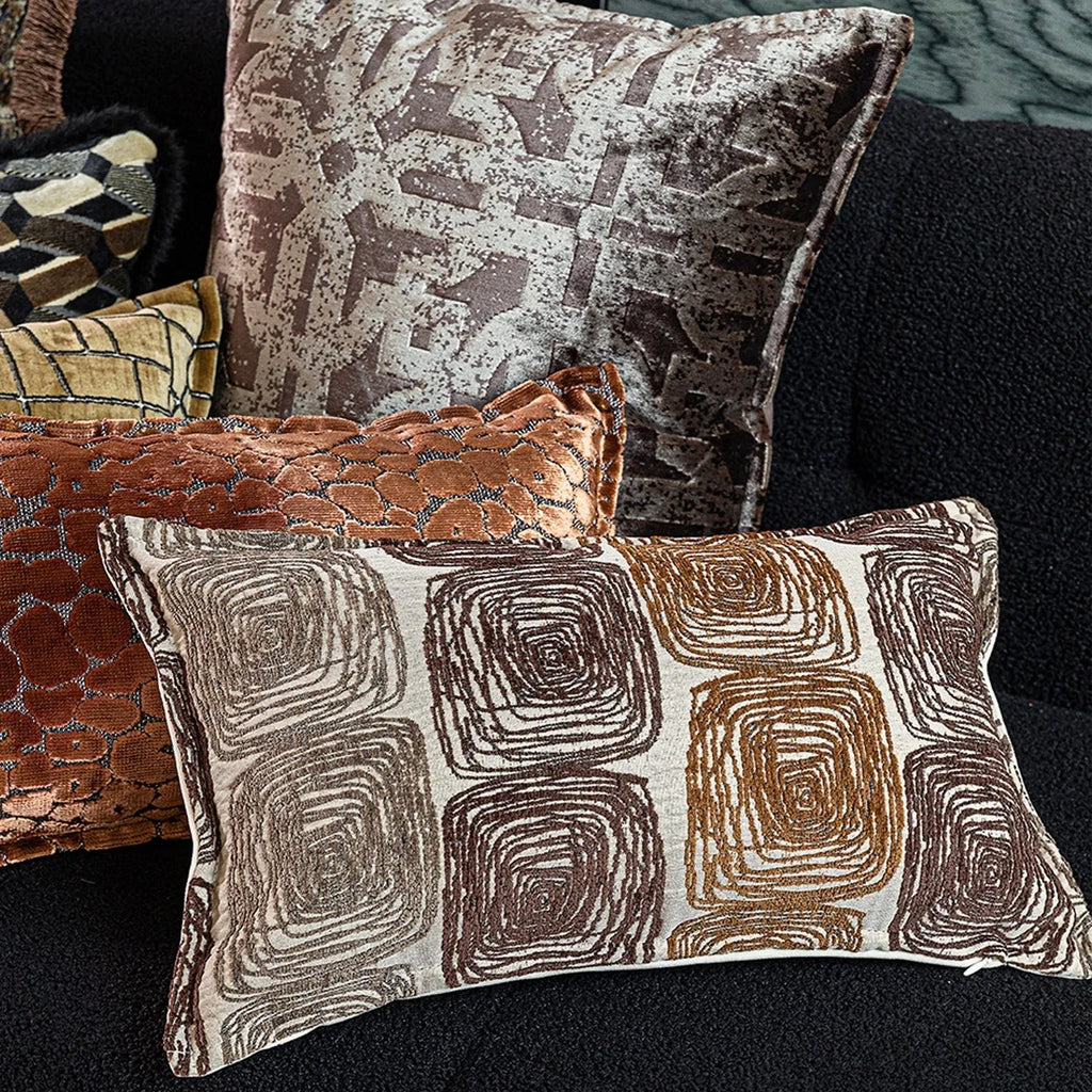 Cream and coffee-coloured abstract coil pattern on square and rectangular polyester pillow covers.