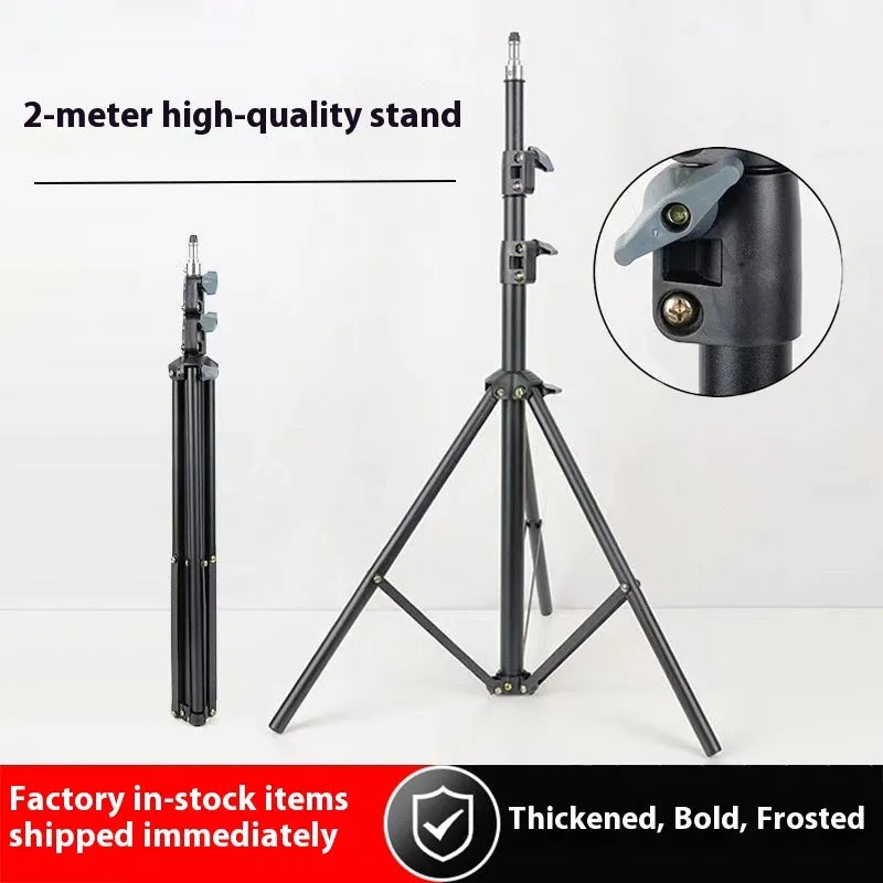 Frosted finish tripod light stand with mobile phone holder mounted, showing carbon steel construction and adjustable legs