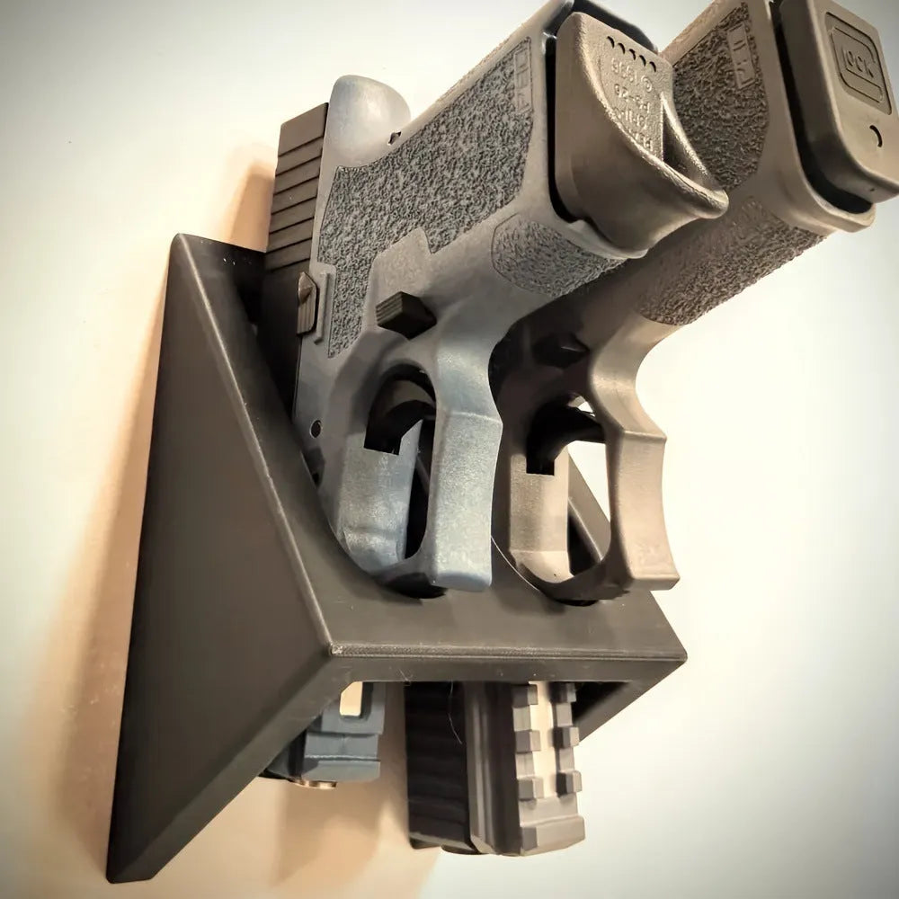 Black punk-style plastic pistol stand for handgun display measuring 10.85cm by 7.6cm