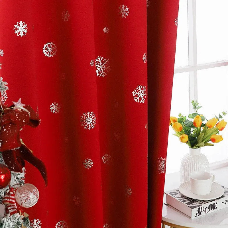 Red polyester snowflake pattern shade cloth curtain with lace loop trim hanging on a window
