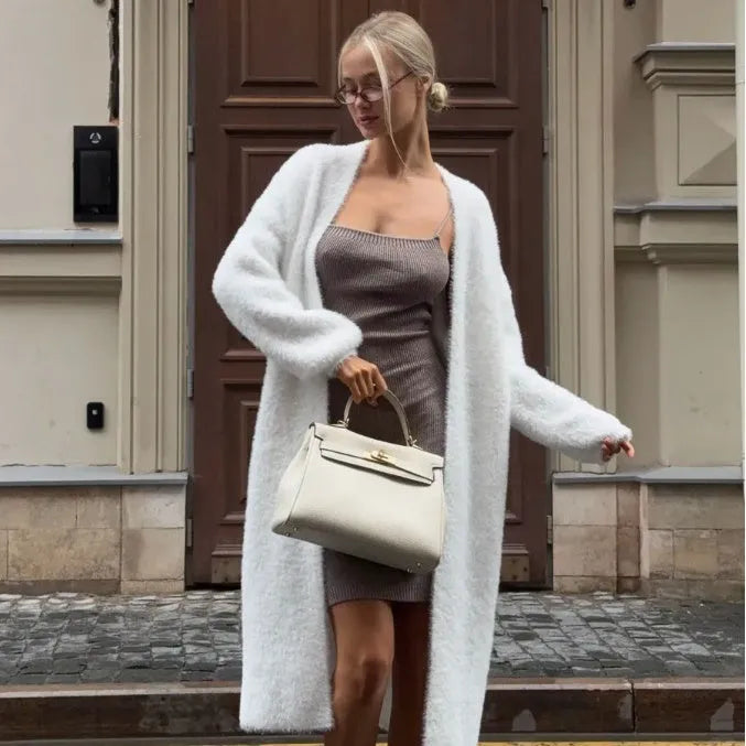 White longline women's cardigan jacket with long sleeves made from thick polyester knit fabric.