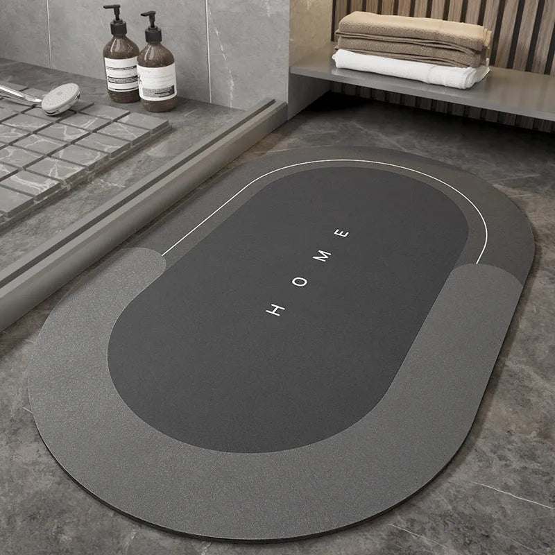 Soft blue oval bathroom floor mat placed on tiles beside a bathtub.