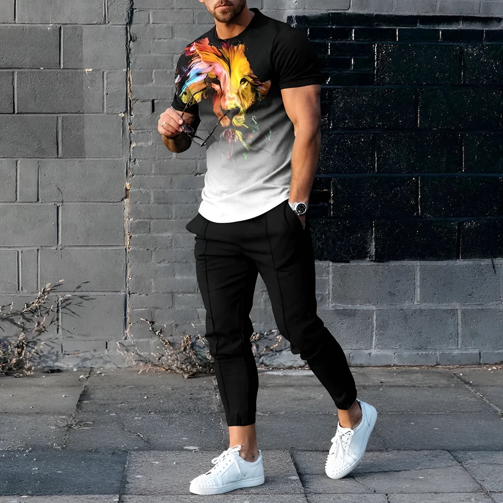 Man wearing a blue short-sleeved round neck pullover and matching trousers from a polyester sportswear set.