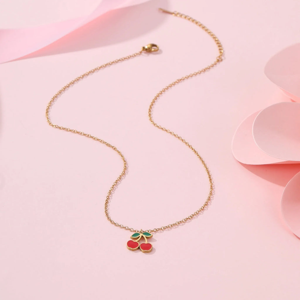 Cherry jewellery set showing necklace, bracelet, earrings, and ring with stainless steel construction and cherry fruit design