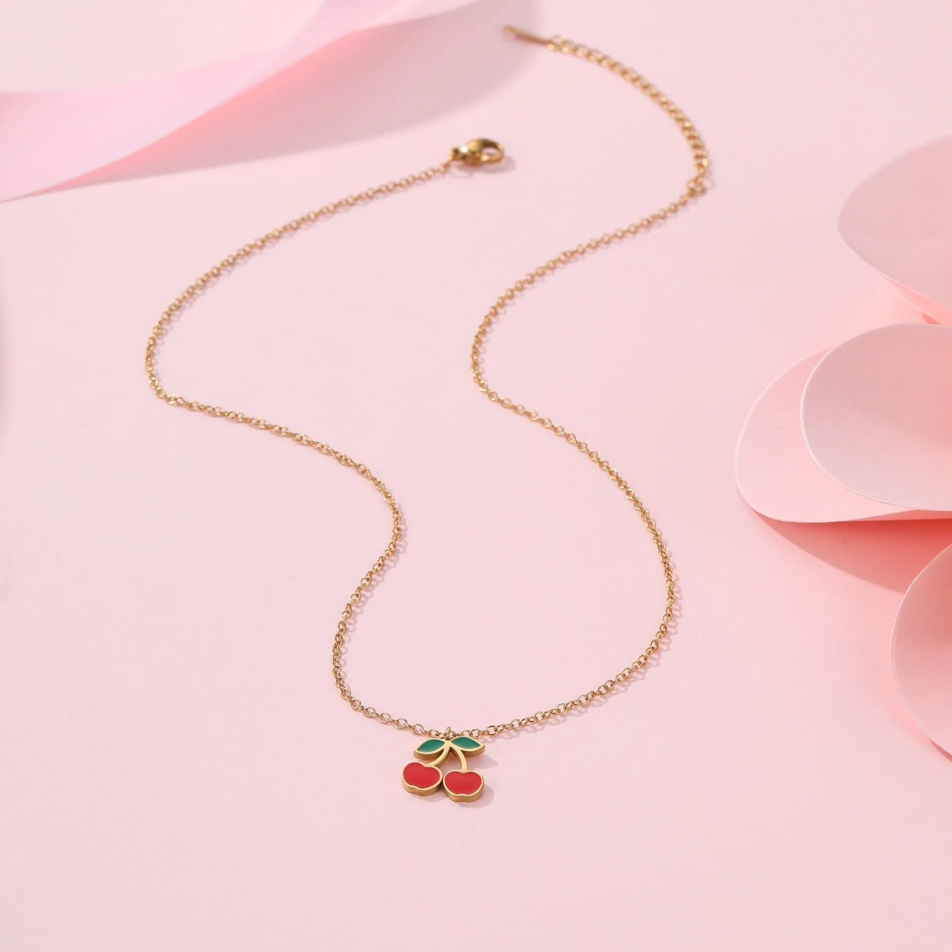 Cherry jewellery set showing necklace, bracelet, earrings, and ring with stainless steel construction and cherry fruit design