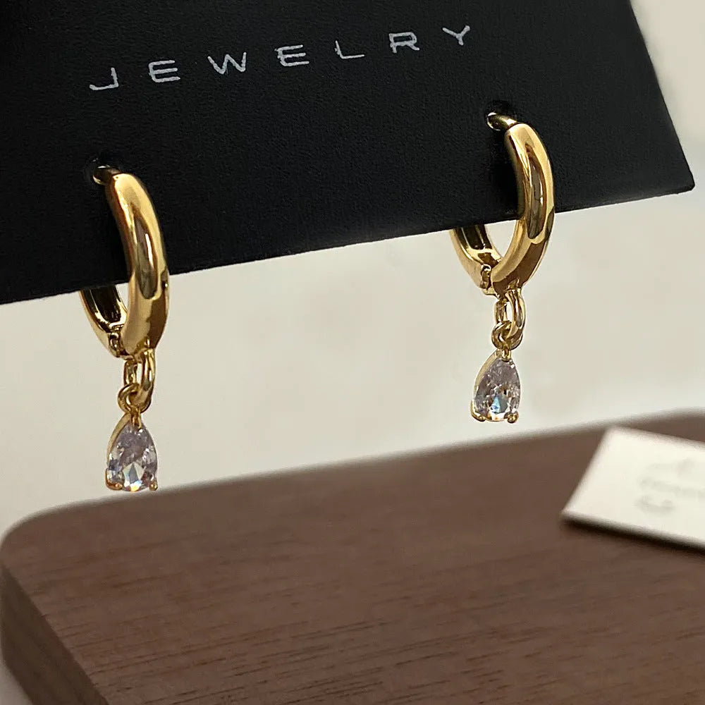 Women's zircon jewellery set showing geometric necklace, matching earrings, and anklet with meteor shower design.