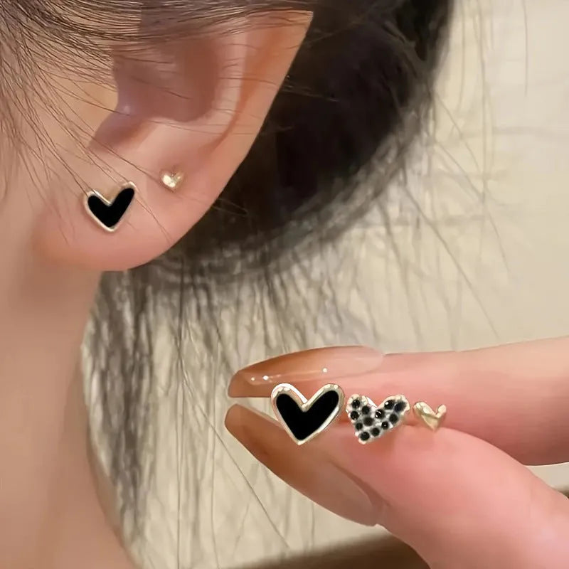 Three pairs of heart-shaped alloy earrings with love motifs in four colour options