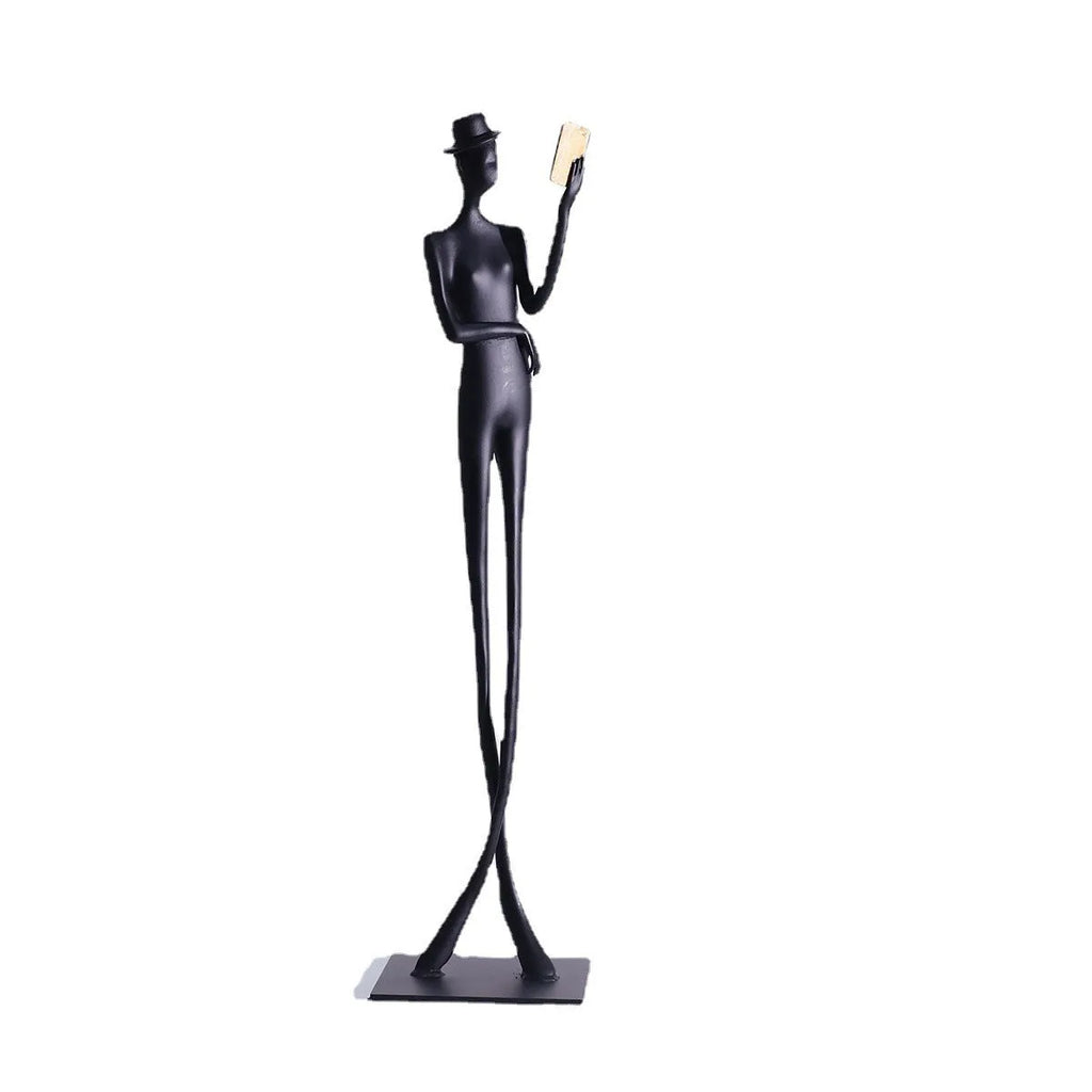 Black metal cast aluminium sculpture of reading woman on square base