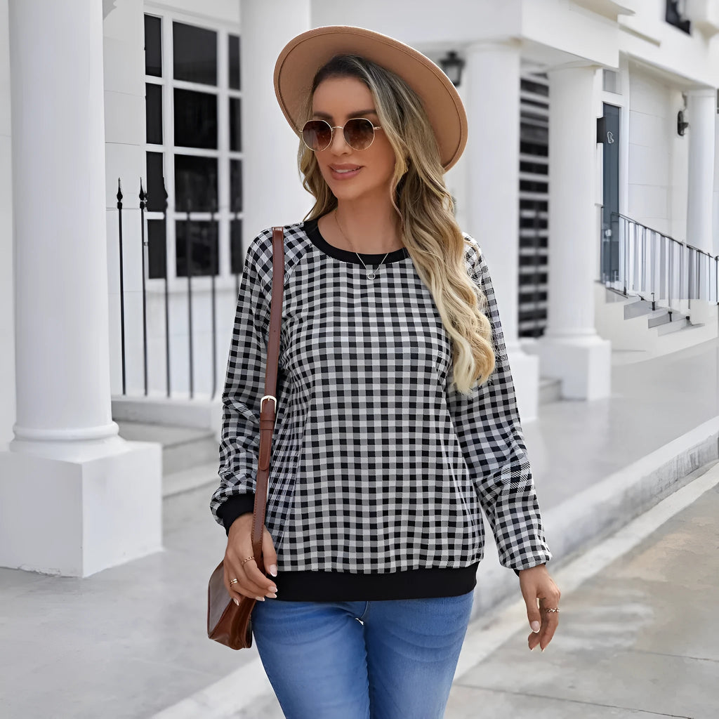 Black long sleeve pullover sweater with printed plaid and stripe pattern on a mannequin