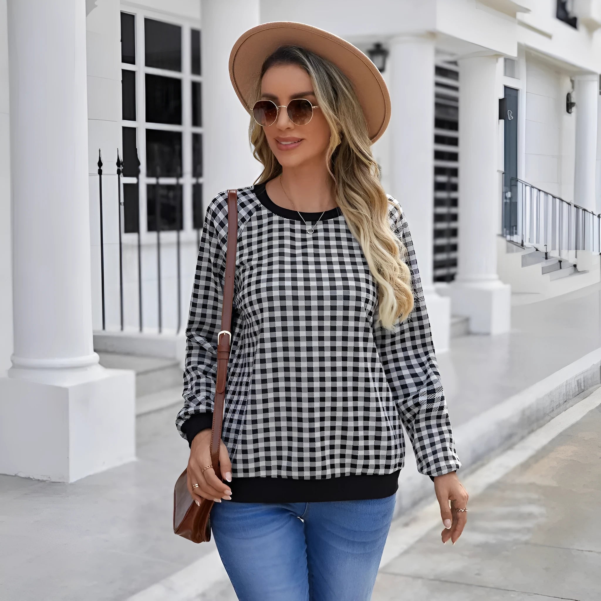 Black long sleeve pullover sweater with printed plaid and stripe pattern on a mannequin