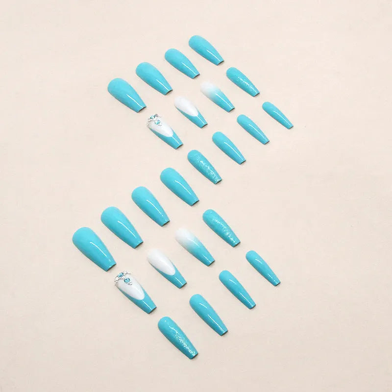 Long ballet shaped false nails in a solid smart blue diamond colour with glue.