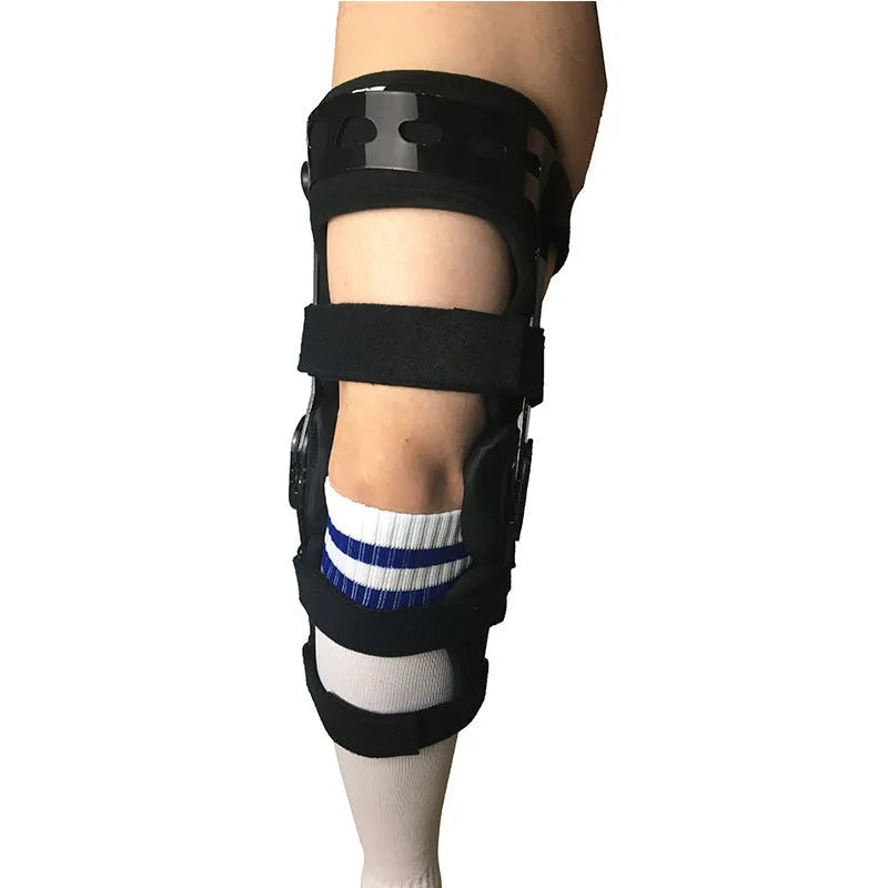 Black anterior ligament knee pad with adjustable straps shown from side view