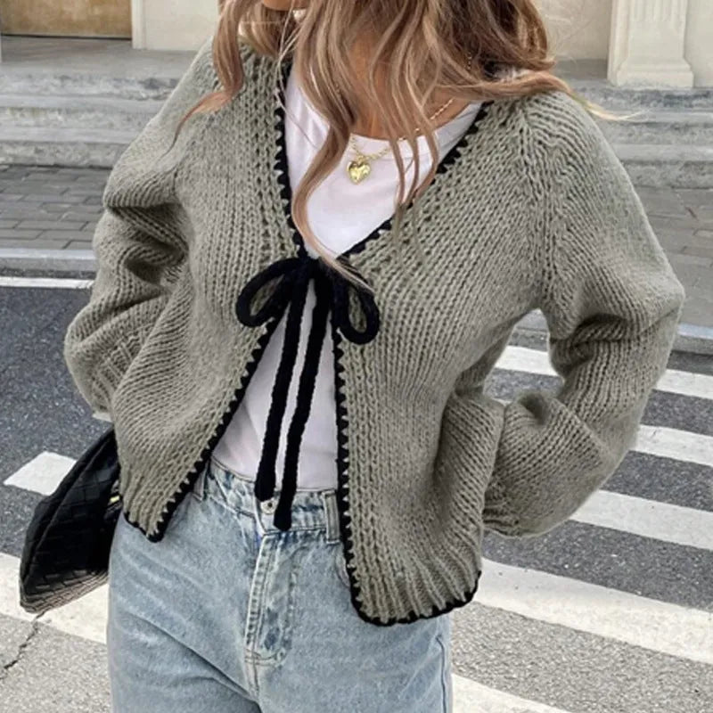 Grey lace-up sweater cardigan with long sleeves, a front crocheted flower, and a loose fit.