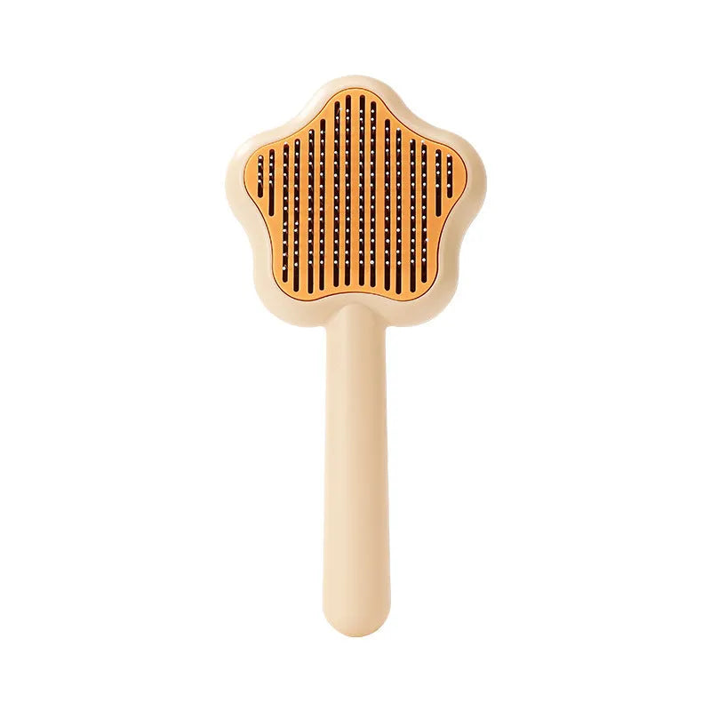 Green stainless steel self-cleaning cat comb with needle bristles on a white background.