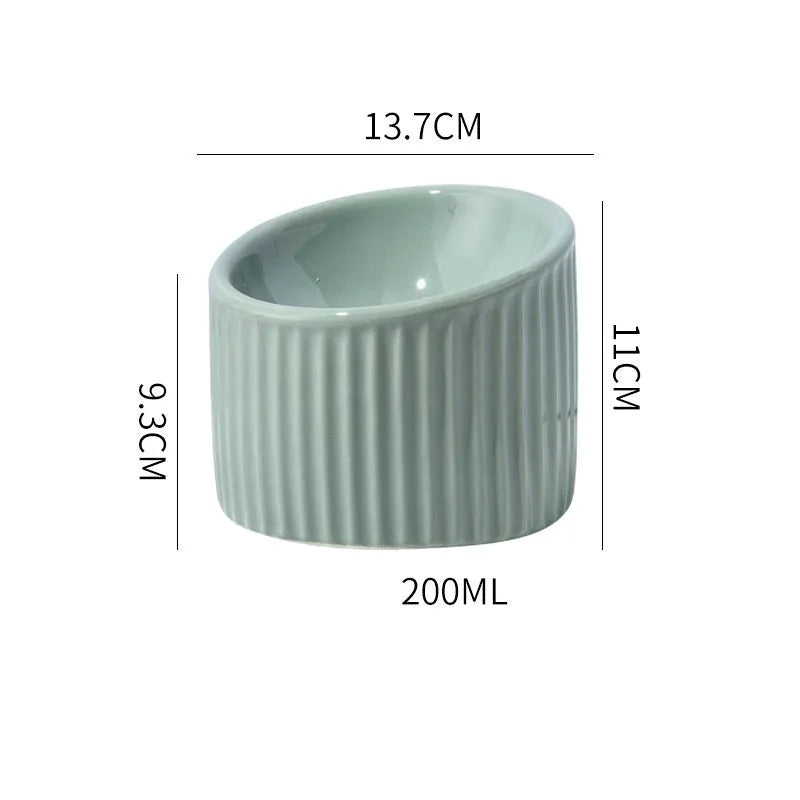 Elevated ceramic cat bowl in green colour with tilted design for whisker-friendly feeding