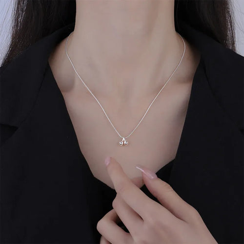 Silver cherry pendant necklace on an adjustable snake bones chain for women.