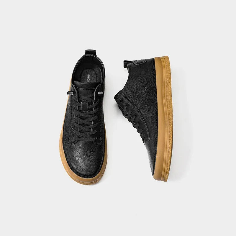 A pair of men's black leather casual shoes with a lace-up front and round toe on a white background.