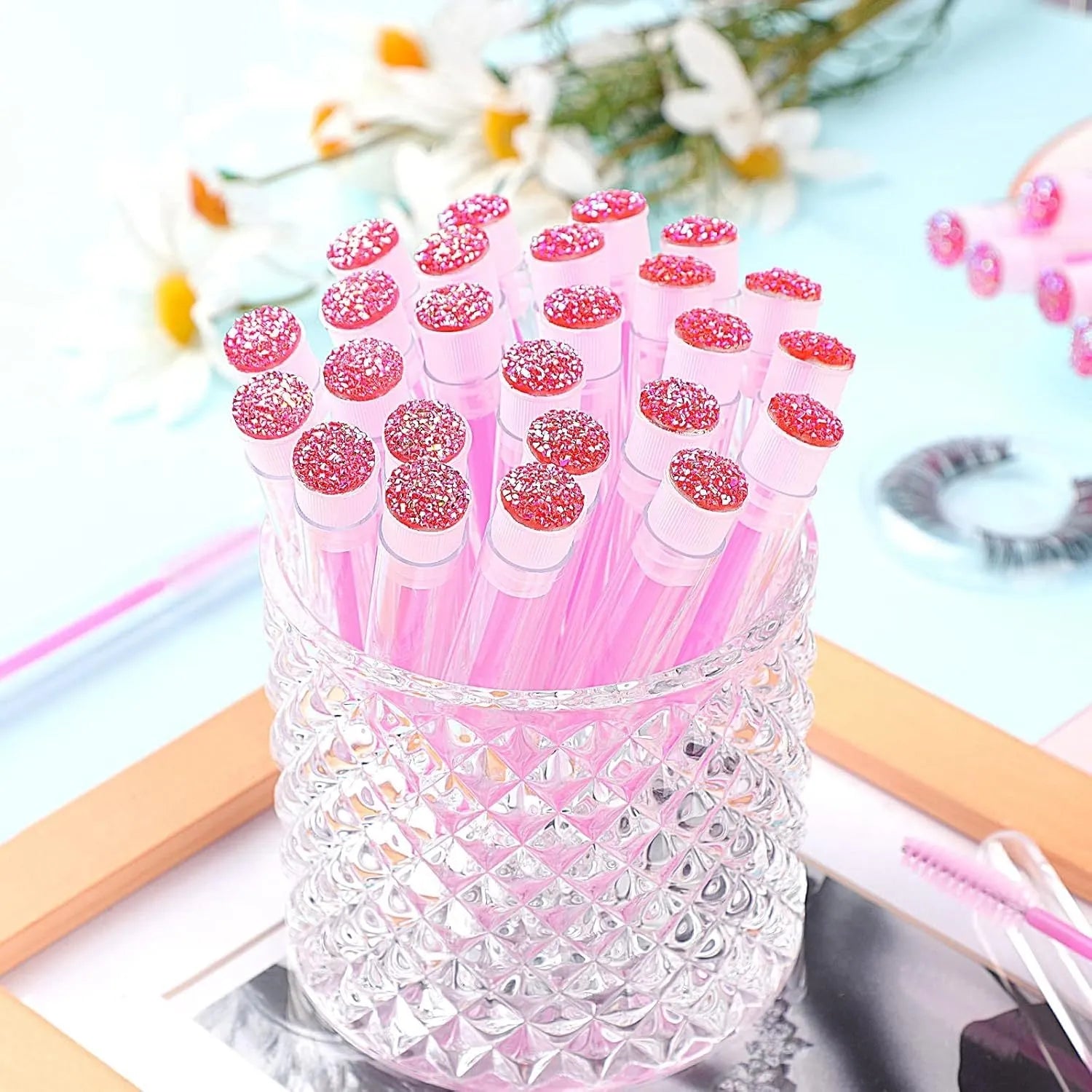Set of coloured disposable mascara wands with clear plastic storage tubes