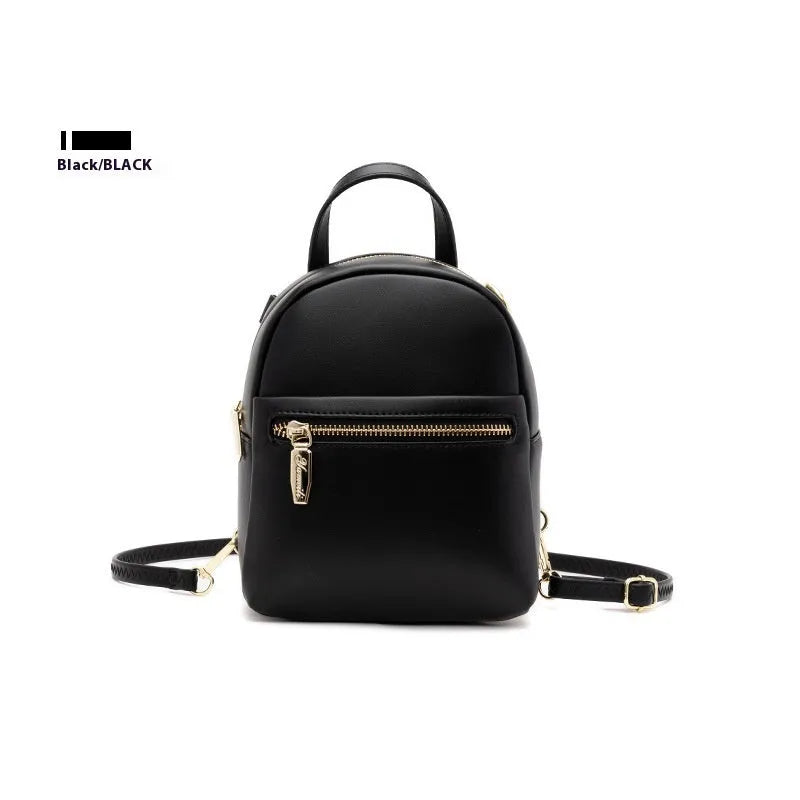 Soft black PU mini backpack with front pockets, shown open to reveal internal mobile phone sleeve and zipper compartment.