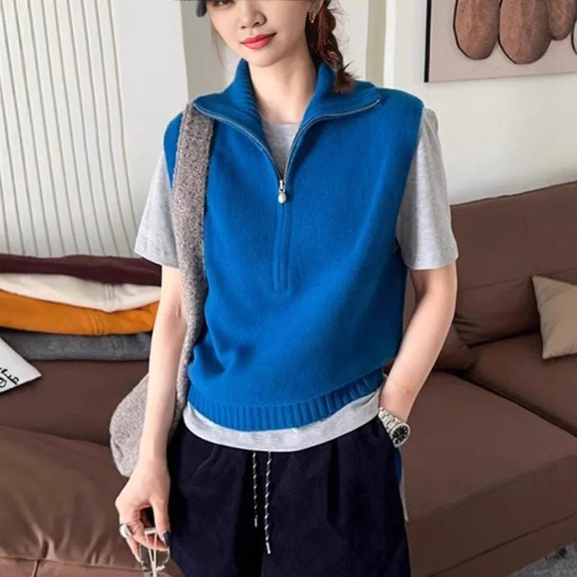 Retro half-zip sleeveless knit vest in solid colour polyester mesh fabric on a hanger.