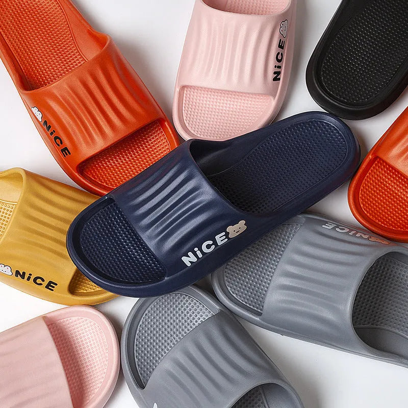 Pair of minimalist EVA flip flop slippers in a choice of six colours, showing the injection moulded non-slip sole.