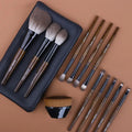 12-piece makeup brush set with wooden handles in a black PU carrying case, including a powder foundation brush.