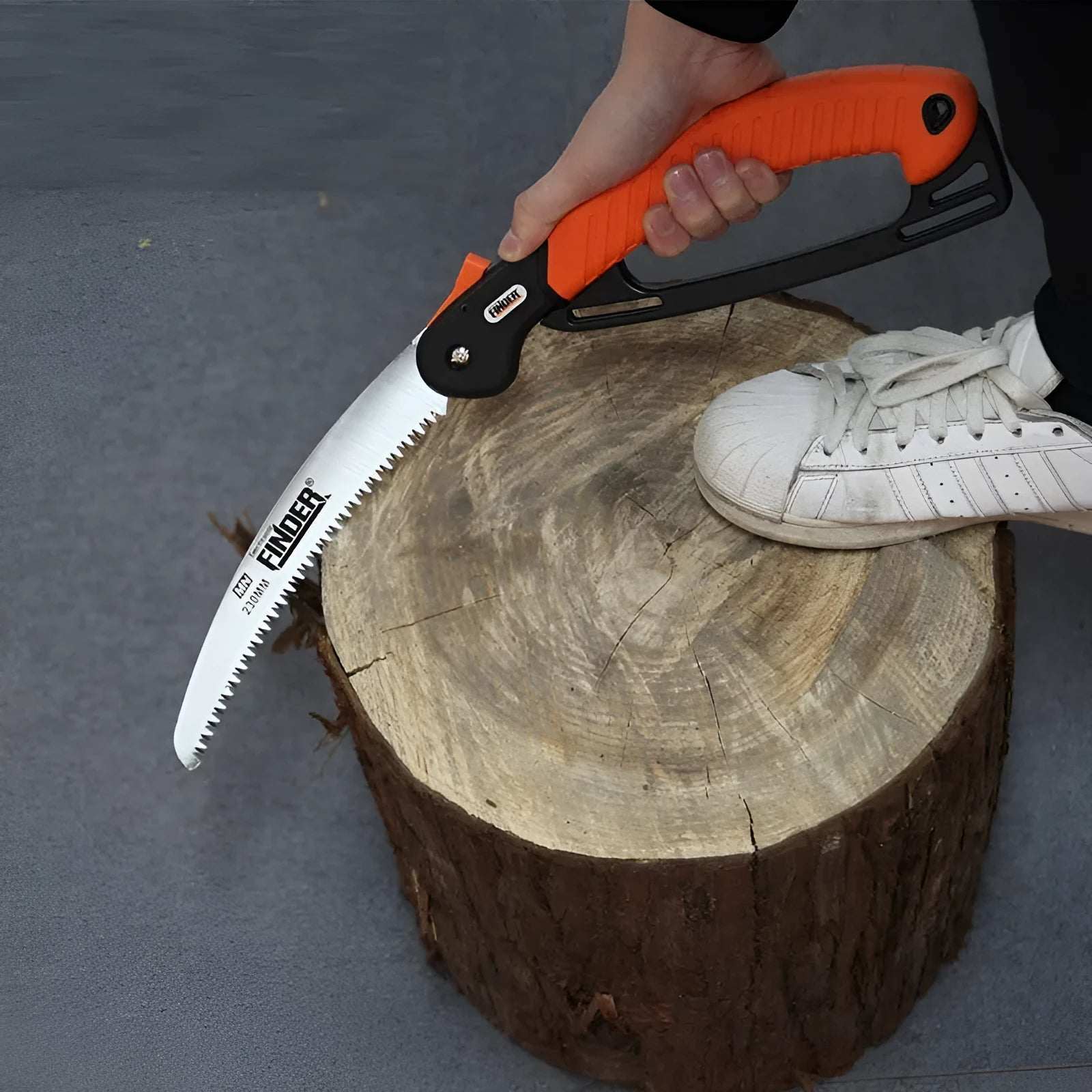 Folding garden saw with orange TPR grip and 9-inch steel blade extended for cutting