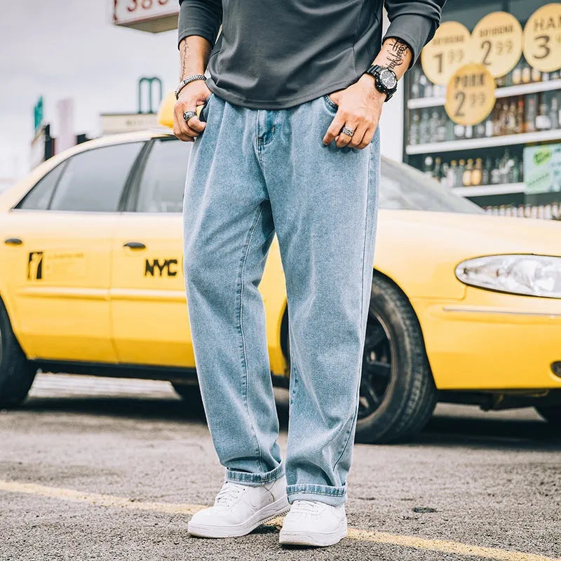 Men's loose straight-leg jeans in cotton denim, shown in dark blue, with a zipper fly and mid-rise waist.