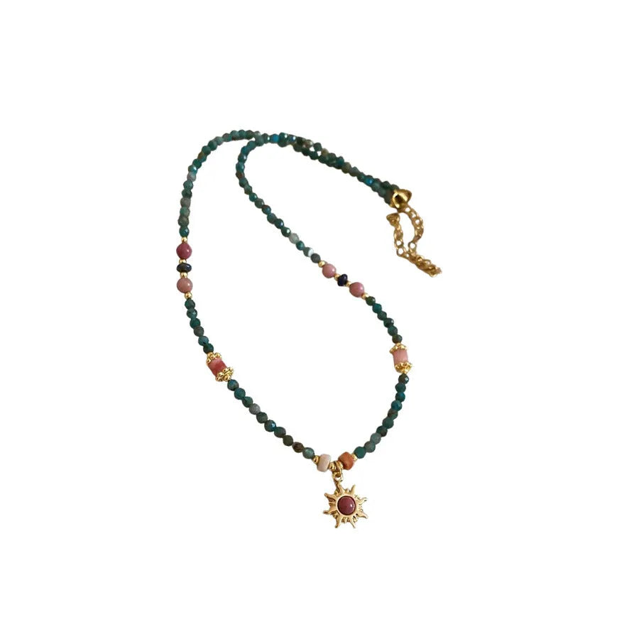 French royal style necklace with sun pendant, freshwater pearls, and adjustable metal chain.