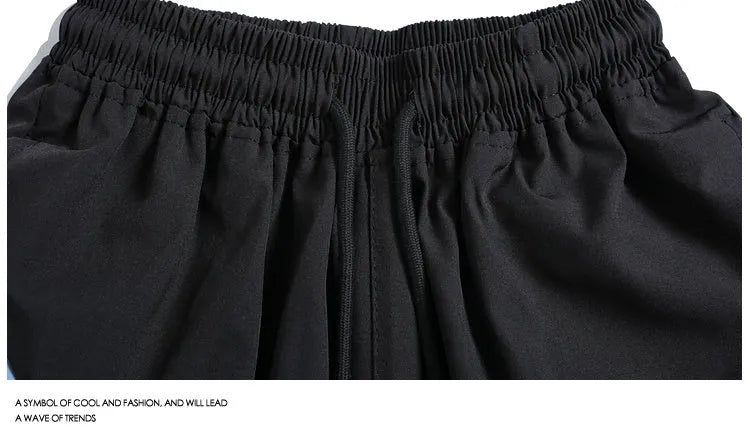 Black loose-fit sports shorts with elastic waistband and above-knee length for training