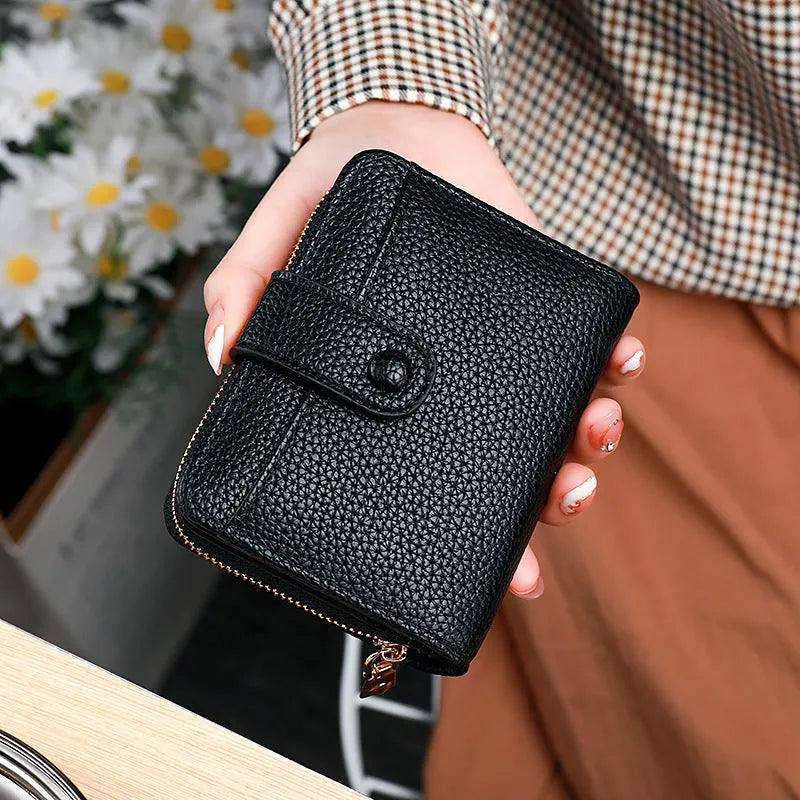 Women's short PU leather wallet with lychee pattern in beige, pink, black, or red.