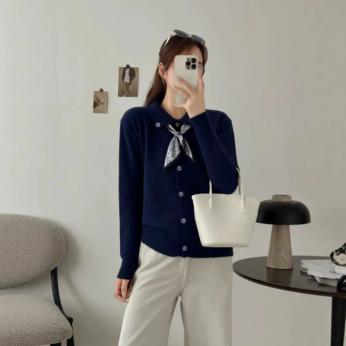 Women's beige lapel scarf collar acrylic cardigan sweater on a hanger.