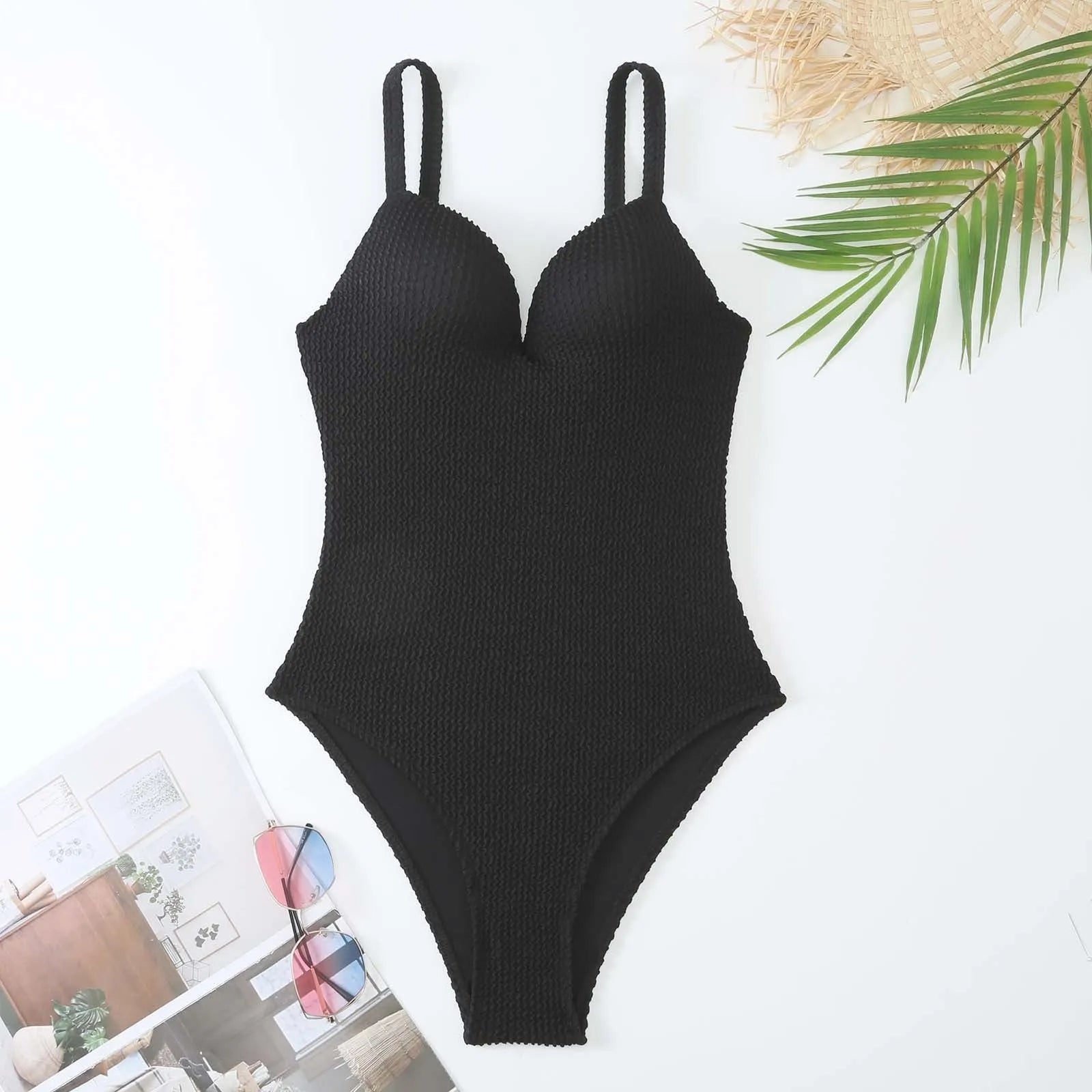 A women's sleeveless one-piece swimsuit on a hanger, shown in black, with other colour options available.