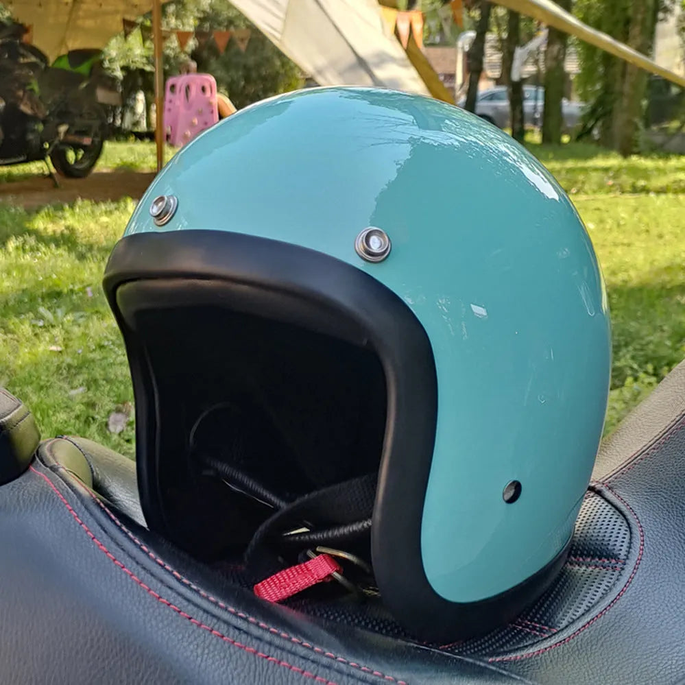Glass fibre retro half motorcycle helmet shown in multiple colour options including cement grey and matte black flower patterns