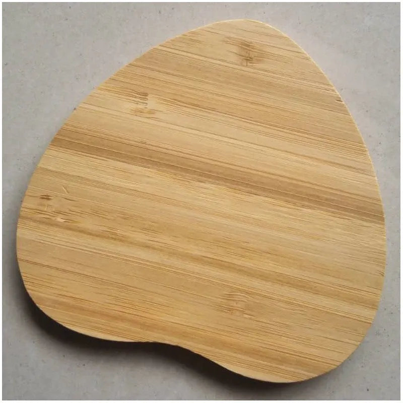 Square wooden bamboo 5W Qi wireless charging pad on a desk.