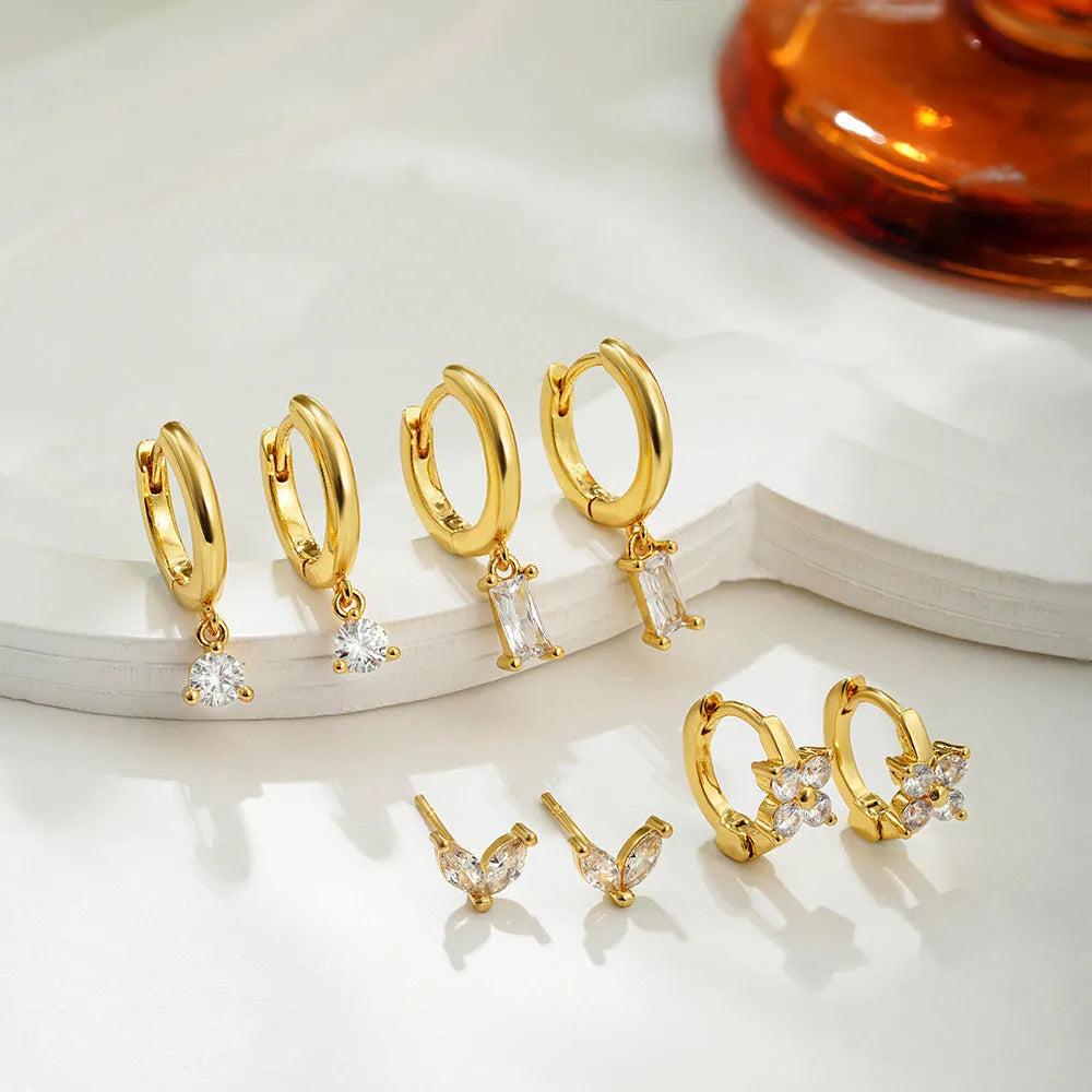 Geometric square zircon copper earrings for women in four-piece set with gold electroplated finish showing star and quadrilateral designs