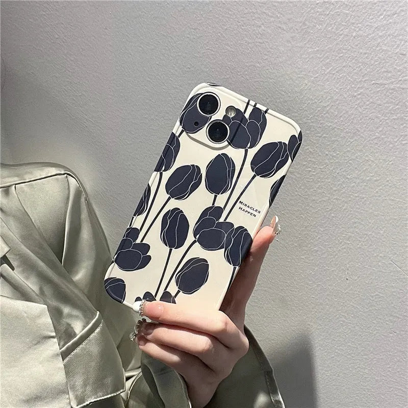 Black silicone iPhone case with a detailed tulip flower print on the back.