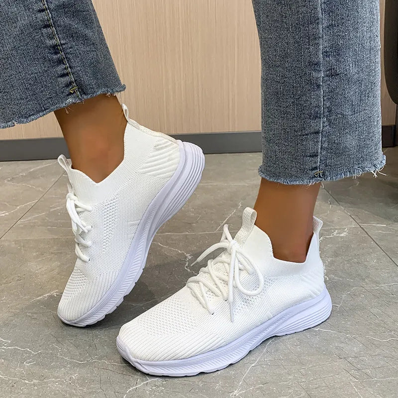 Women's cream running shoes with breathable mesh upper and flat rubber sole