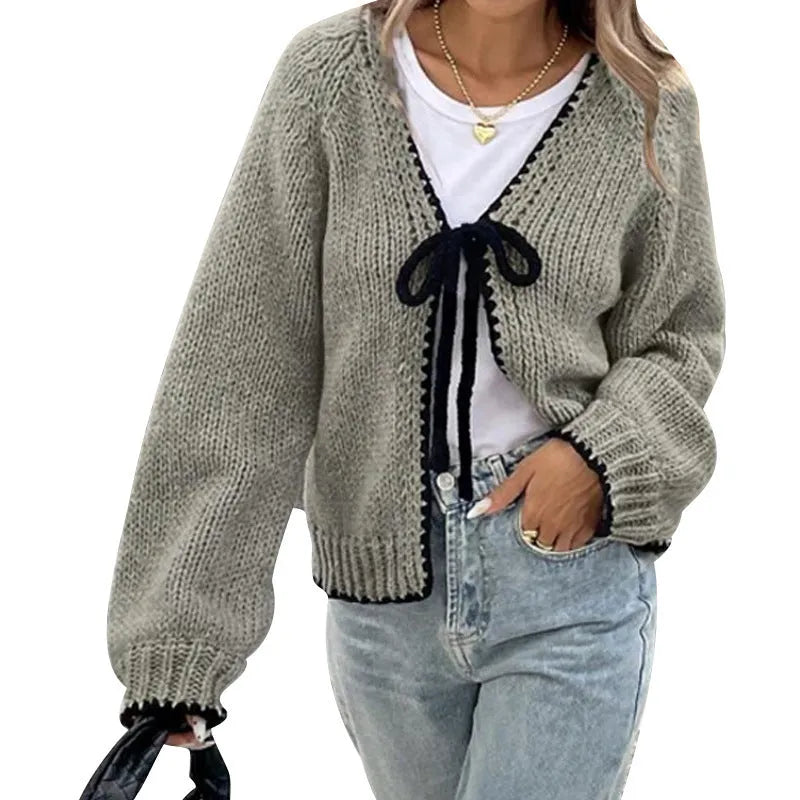 Grey lace-up sweater cardigan with long sleeves, a front crocheted flower, and a loose fit.