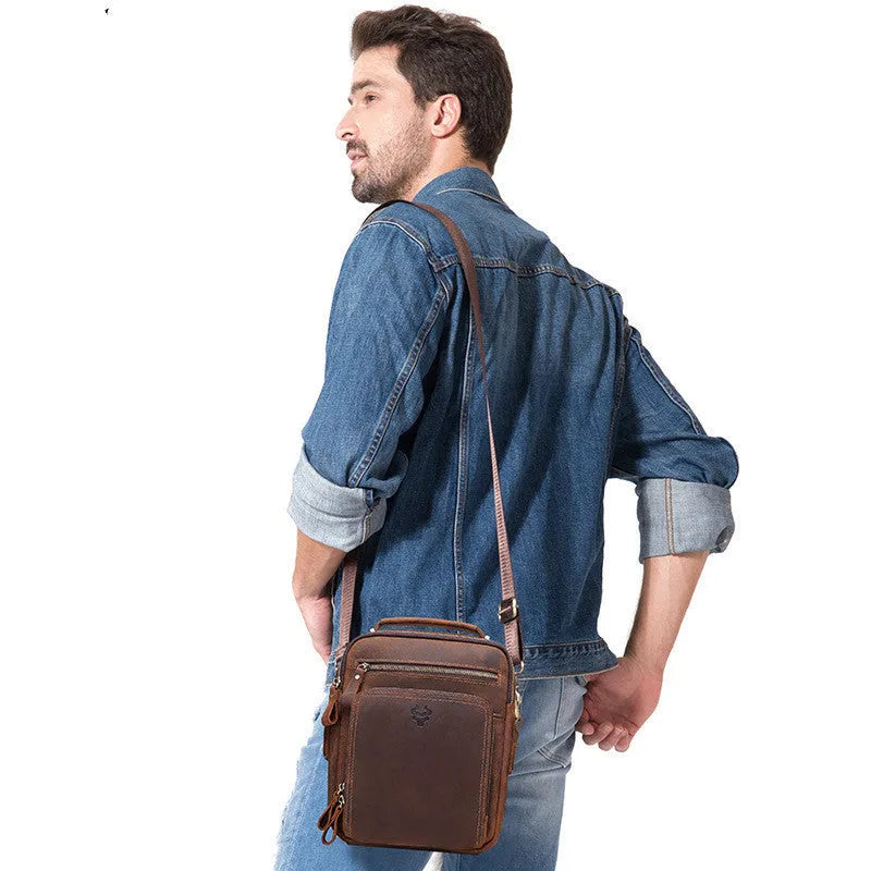 Men's brown crazy horse leather crossbody bag with sewing line detail and single shoulder strap.