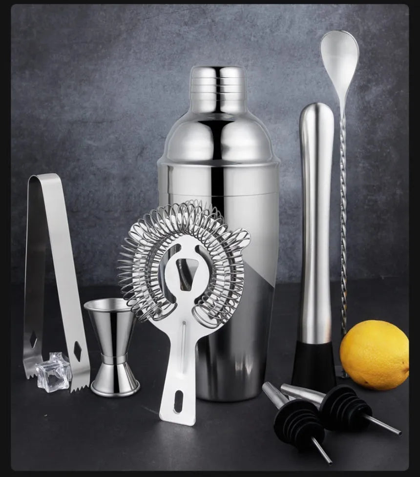 23-piece stainless steel and acrylic cocktail set with shakers and bar tools on a counter.