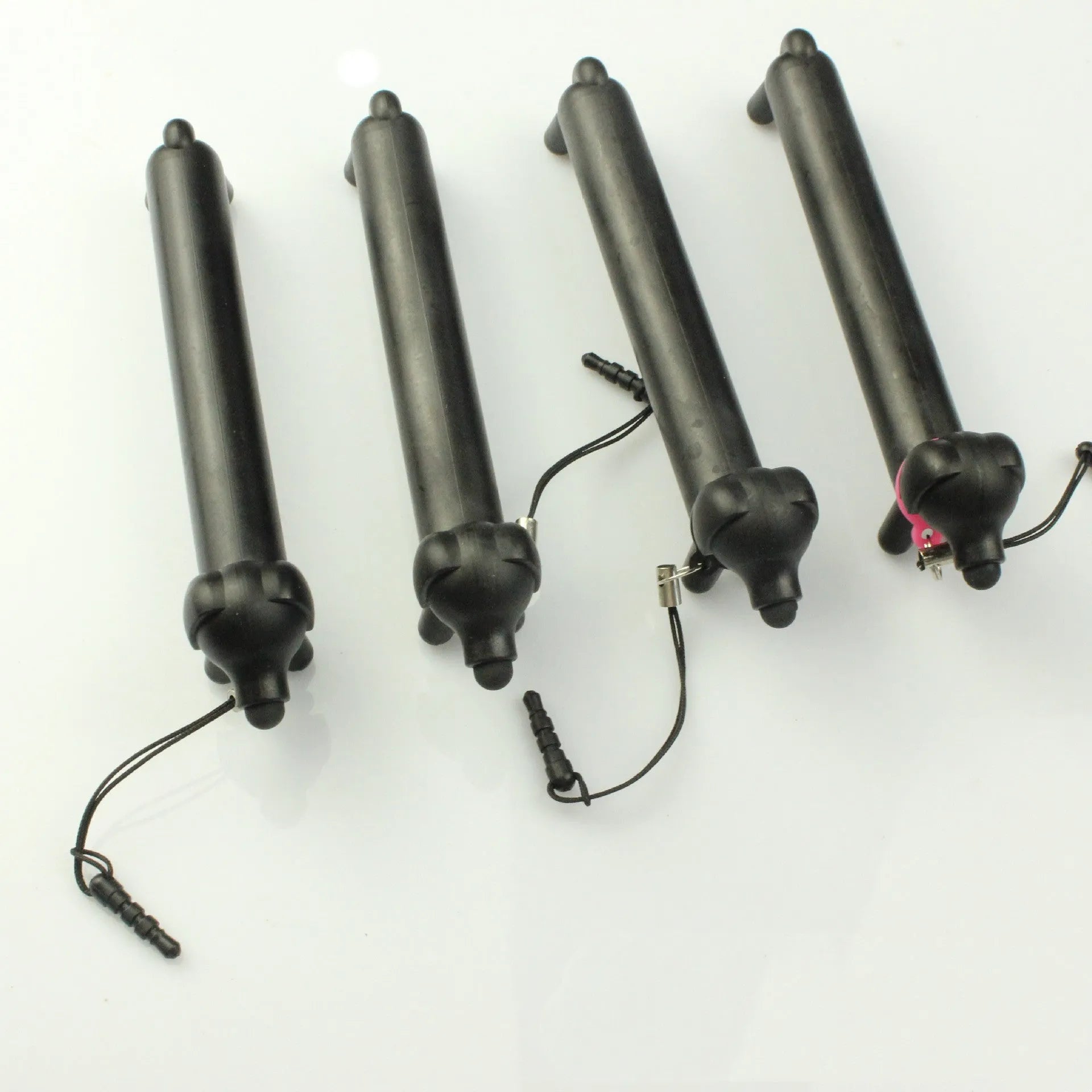 Black dog-shaped touch screen stylus with 12cm length shown on desk